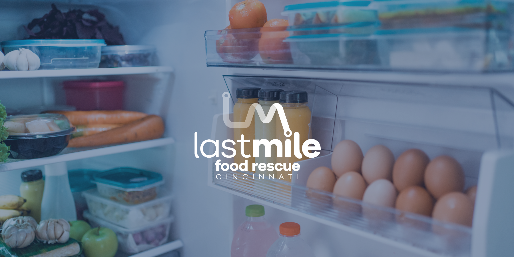 Organized Fridge — Restock Culture and Food Waste Awareness Inside view of a neatly organized fridge with fresh produce, eggs, and drinks, symbolizing fridge restock trends and food waste awareness.