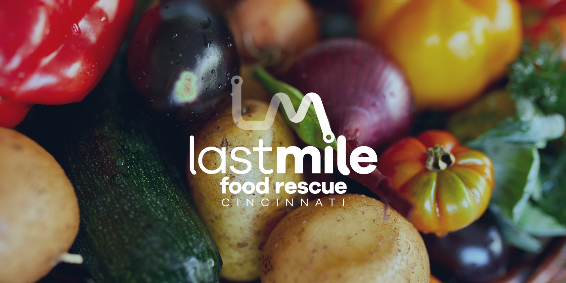 Last Mile Food Rescue – Fresh Rescued Produce Fresh rescued produce including peppers, potatoes, and zucchini with the Last Mile Food Rescue Cincinnati logo overlayed.